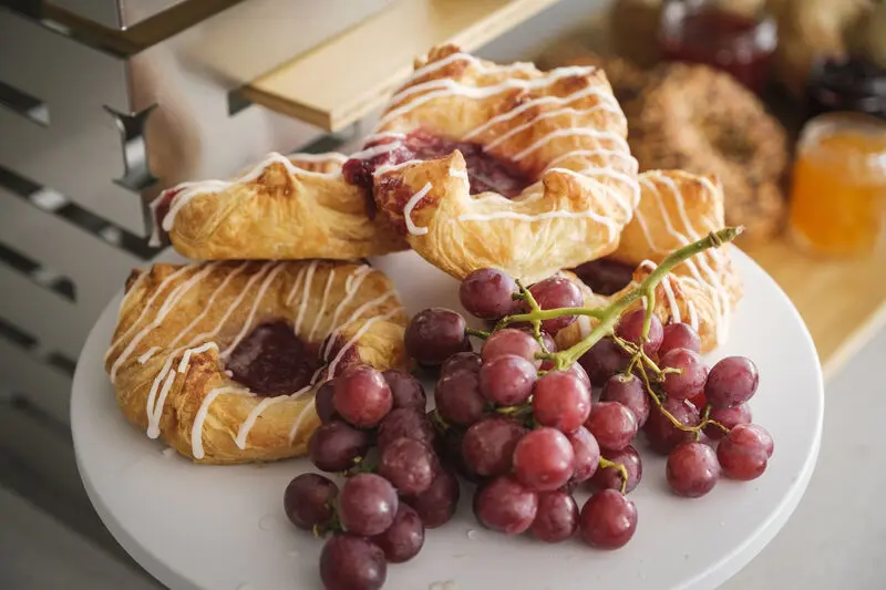 Danishes and grapes on a plate